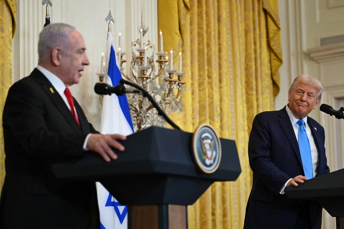 US President Donald Trump listens to Israels Prime Minister Benjamin Netanyahu during a press conference in the East Room of the White House in Washington, DC, on February 4, 2025. Netanyahu met Trump at the White House Tuesday for crucial talks on the truce with Hamas, as the US president suggested permanently resettling Palestinians from war-battered Gaza. (Photo by ANDREW CABALLERO-REYNOLDS / AFP)