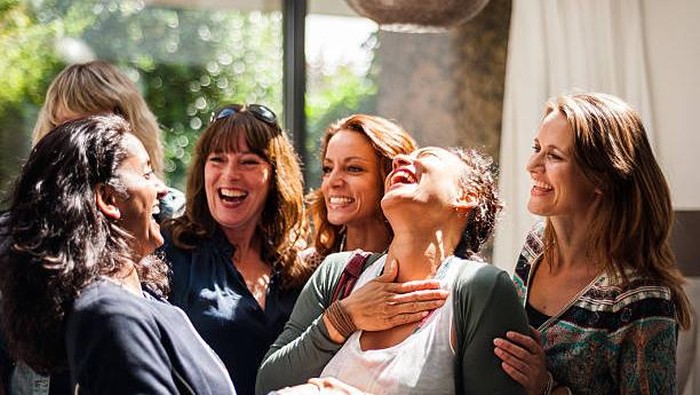 Group of women seeing one another at reunion. Lots of happiness and fun.