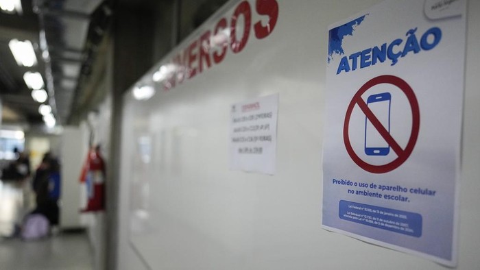 Students play cards during recess in their first week at school under a new law that forbids the use of mobile phones on campus, at Porto Seguro School in Sao Paulo, Thursday, Feb. 6, 2025. (AP Photo/Andre Penner)