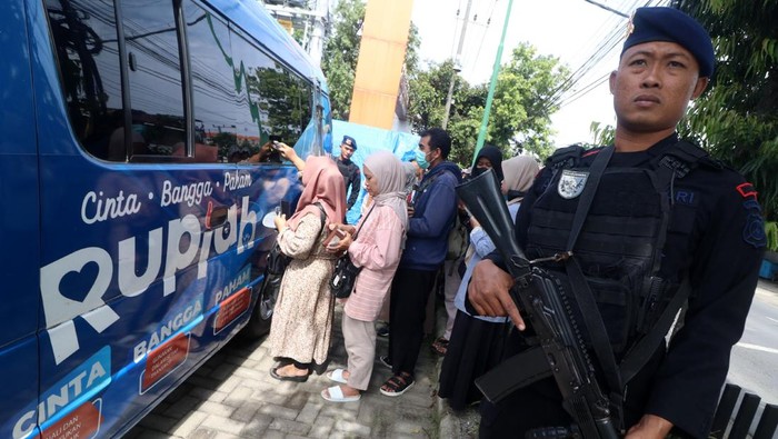 Sejumlah warga antre untuk menukarkan uang baru pada mobil kas keliling Bank Indonesia di Pasar Grosir Ngronggo, Kota Kediri, Jawa Timur, Jumat (7/2/2025). Bank Indonesia membuka menukarkan uang di pasar sebagai upaya memudahkan masyarakat khususnya pedagang pasar untuk menukarkan uang rusaknya dengan uang layak edar ataupun uang dengan nominal pecahan tertentu guna memudahkan transaksi. ANTARA FOTO/Prasetia Fauzani/YU