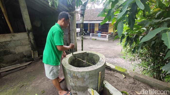 Sukamto saat menunjukkan alat yang digunakan untuk membuat biogas di samping kandang sapi miliknya di Balong Wetan, Umbulharjo, Cangkringan, Sleman, Jumat (7/2/2025)