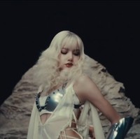 Dalam tampilan lainnya, Lisa terlihat bak seorang diva. Rambut pirangnya ditata dengan gelombang besar yang mengingatkan pada gaya retro Hollywood. Makeup bold, dengan bibir merah gelap dan eyeliner yang tajam, menambah kesan dramatis sekaligus memukau.  Foto: Instagram/@lalalalisa_m @dojacat