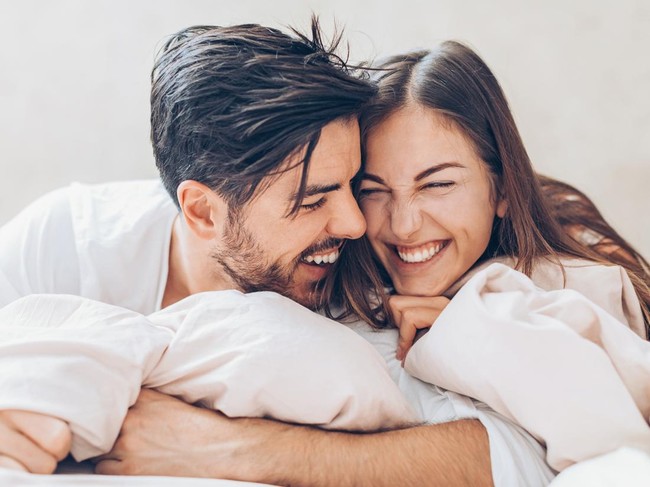 Young couple man and woman intimate relationship on bed feet