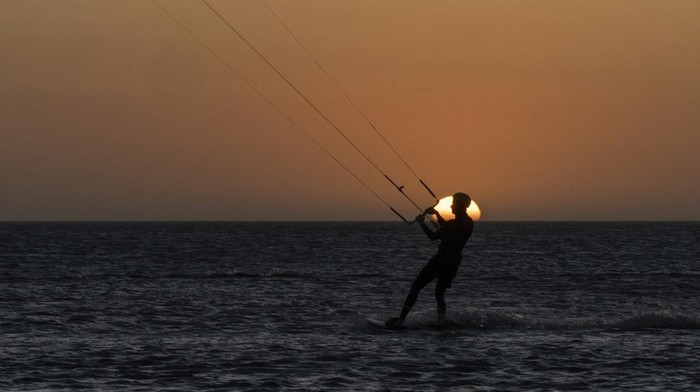 A member of the Wayuu Indigenous group kitesurfs in Cabo de la Vela, Colombia, Friday, Feb. 7, 2025. (AP Photo/Ivan Valencia)