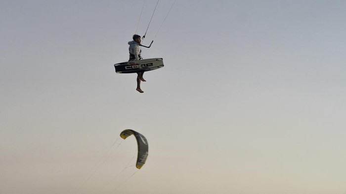 A member of the Wayuu Indigenous group kitesurfs in Cabo de la Vela, Colombia, Friday, Feb. 7, 2025. (AP Photo/Ivan Valencia)