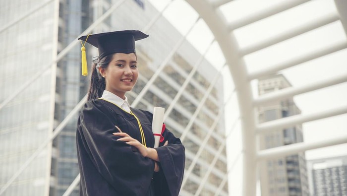 Graduate Student and Success Education in University Concept. Happy Asian student woman graduate diploma and MBA degree in asian college.
