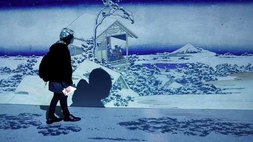 A visitor attends an exhibition that uses cutting-edge technology to bring to life the work of iconic samurai-era ukiyo-e artist Katsushika Hokusai at 'HOKUSAI: ANOTHER STORY in TOKYO', technical wizardry from Sony PCL Inc. and Ars Techne Corp, and the woodblock prints provided by the Yamanashi Prefectural Museum that owns the original work, during a preview event in Tokyo, Japan January 30, 2025.  REUTERS/Issei Kato
