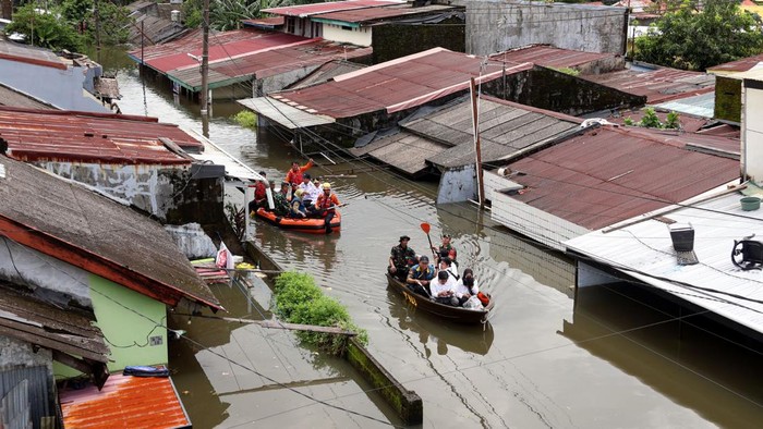 Seorang anggota Babinsa menaiki perahu untuk melihat kondisi banjir di Perumnas Antang, Makassar, Sulawesi Selatan, Rabu (12/2/2025). Ratusan rumah yang tersebar di empat kecamatan di daerah itu terendam banjir sejak Senin (10/2) akibat hujan dengan intensitas tinggi yang bersamaan dengan terjadinya gelombang pasang air laut.