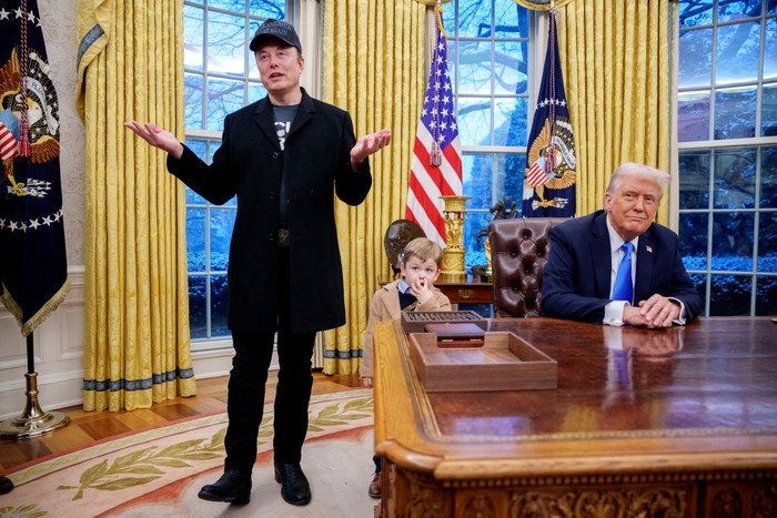 WASHINGTON, DC - FEBRUARY 11: Tesla and SpaceX CEO Elon Musk, accompanied by U.S. President Donald Trump (R), and his son X Musk, speaks during an executive order signing in the Oval Office at the White House on February 11, 2025 in Washington, DC. Trump is to sign an executive order implementing the Department of Government Efficiencys (DOGE) 
