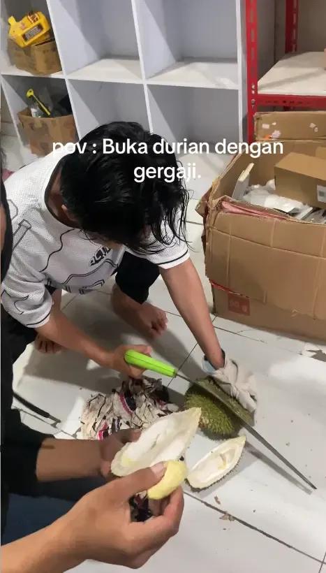 Kocak! Pria Ini Belah Buah Durian Pakai Gergaji Besar