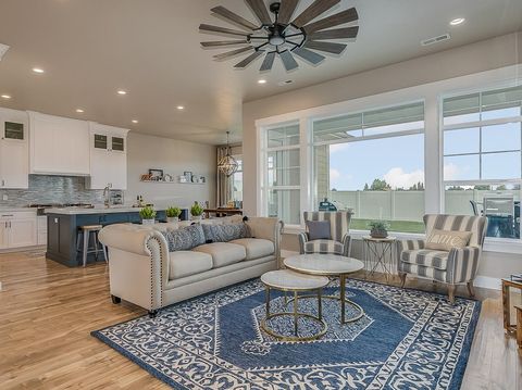 Farmhouse style ceiling fan and decorative rug in front family room
