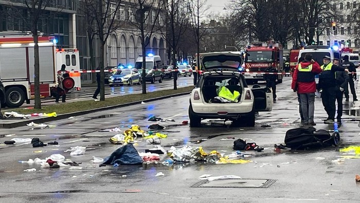 Police walks past a car which drove into a crowd in Munich, Germany, February 13, 2025, injuring several people.    REUTERS/Wolfgang Rattay