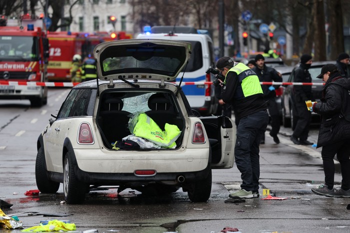 Police walks past a car which drove into a crowd in Munich, Germany, February 13, 2025, injuring several people.    REUTERS/Wolfgang Rattay