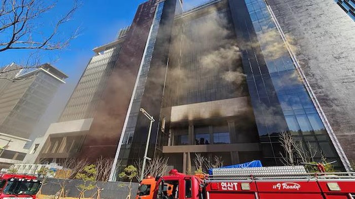 Smoke rises from a building which is currently under construction in Busan, South Korea, February 14, 2025. Yonhap via REUTERS Purchase Licensing Rights