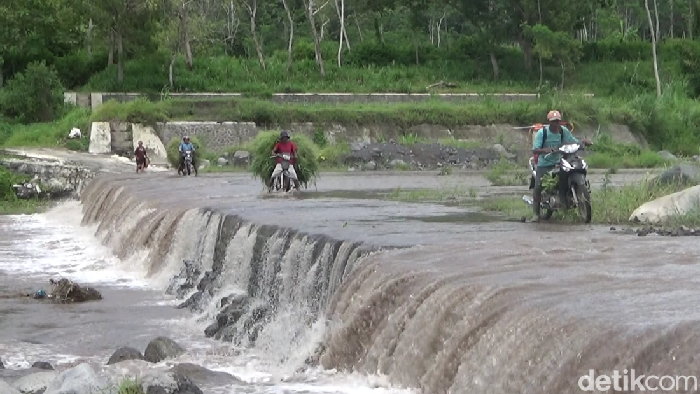 Warga Menyebrangi Aliran Lahar Semeru