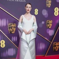 Pesona Saoirse Ronan sukses terpancar berkat gaun Louis Vuitton yang elegan dengan detail yang menyerupai origami. (Foto: Joel C Ryan/Invision/AP)