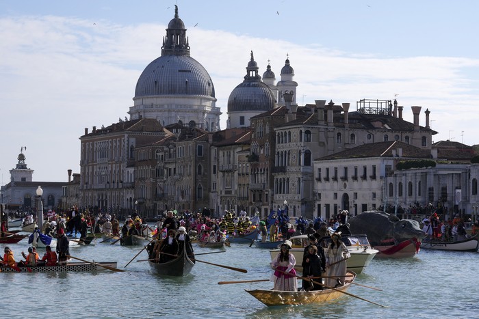 Boats sail during the traditional rowing parade, part of the historical Venice Carnival, in Venice, Italy, Sunday, Feb. 16, 2025. (AP Photo/Antonio Calanni)