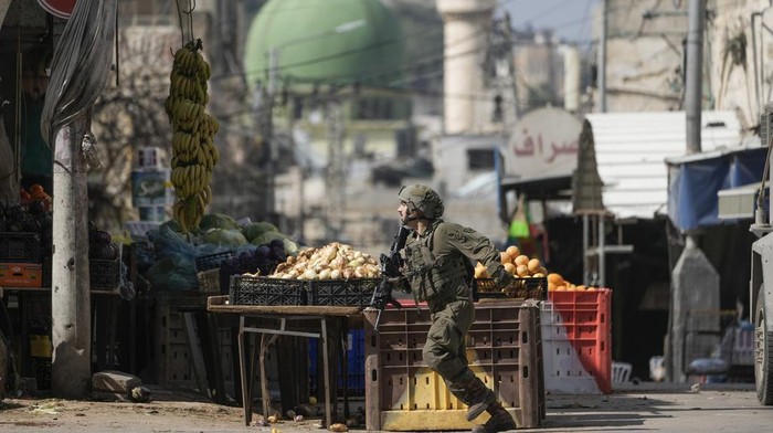 An Israeli soldier takes position during an army operation in the West Bank city of Nablus, Sunday, Feb. 16, 2025. (AP Photo/Majdi Mohammed)