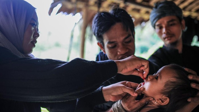 Bidan Puskesmas Cisimeut Rika Nopita memberikan vitamin A kepada anak Suku Badui di Kampung Pamoean, Lebak, Banten, Minggu (16/2/2025). Pemberian vitamin A dengan menyasar sebanyak 119 anak balita Suku Badui usia 6-59 bulan di empat perkampungan di pedalaman Badui tersebut dilakukan guna memenuhi kebutuhan gizi anak sekaligus menangani permasalahan kesehatan mata, dan memberikan kekebalan imun tubuh bagi anak pedalaman. ANTARA FOTO/Muhammad Bagus Khoirunas/Spt.