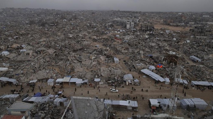 An aerial photograph taken by a drone shows tents between the destruction caused by the Israeli air and ground offensive in Jabaliya, Gaza Strip, on Sunday, Feb. 16, 2025. (AP Photo/Mohammad Abu Samra)