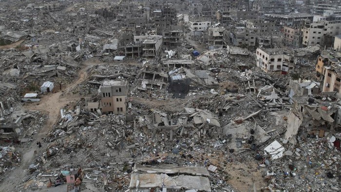 An aerial photograph taken by a drone shows tents between the destruction caused by the Israeli air and ground offensive in Jabaliya, Gaza Strip, on Sunday, Feb. 16, 2025. (AP Photo/Mohammad Abu Samra)