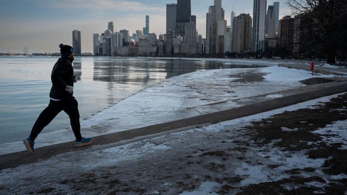 CHICAGO, ILLINOIS - FEBRUARY 17: A runner runs along the shore of Lake Michigan as temperatures dipped into the single-digits on February 17, 2025 in Chicago, Illinois. Temperatures are expected to remain below normal in the city for the remainder of the week. (Photo by Scott Olson/Getty Images)