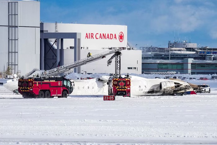 First responders work at the Delta Air Lines plane crash site at Toronto Pearson International Airport in Mississauga, Ontario, Canada February 17, 2025. REUTERS/Arlyn McAdorey Purchase Licensing Rights
