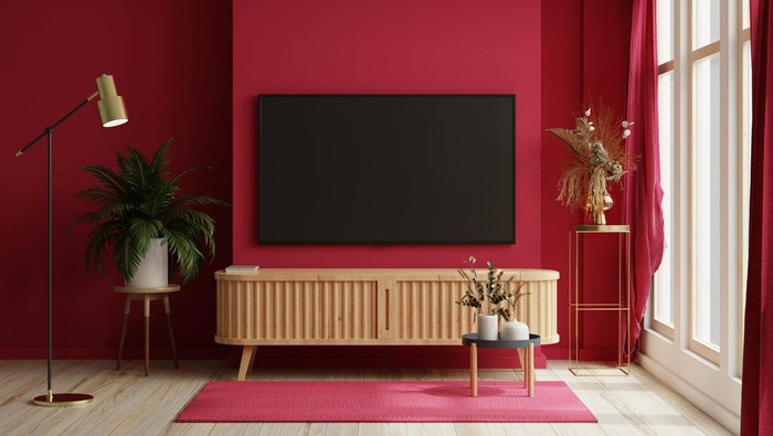 TV on the cabinet in modern living room on white viva magenta wall background.3d rendering