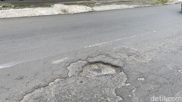 Jalan rusak di Jalan Prof Dr Hamka, depan TPU Giriloyo Ngaliyan, Kelurahan Tambakaji, Kecamatan Ngaliyan, Kota Semarang, Rabu (19/2/2025).