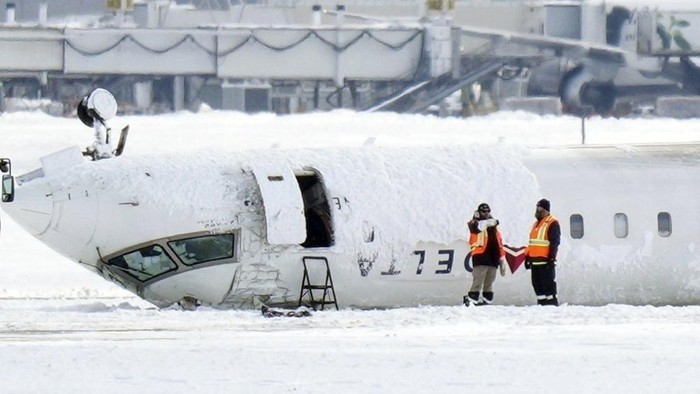 A Delta Air Lines plane lies upside down at Toronto Pearson Airport on Tuesday, Feb. 18, 2025. (Chris Young/The Canadian Press via AP)