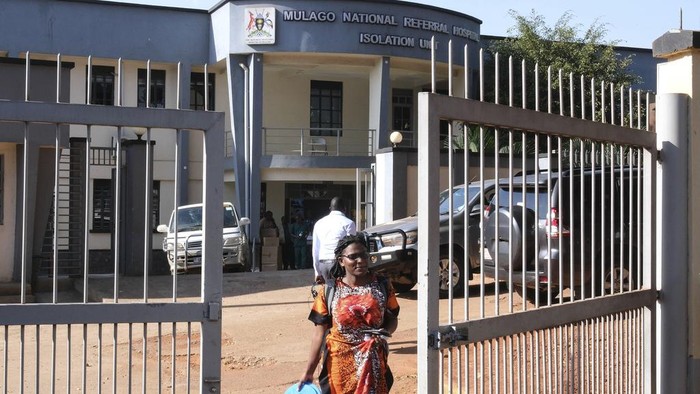 A health worker walks outside Mulago Referral Hospital in Kampala, Uganda Tuesday, Feb. 18, 2025. (AP Photo/Hajarah Nalwadda)
