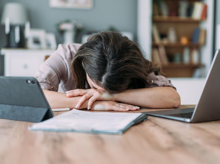 Shot of businesswoman sleeping on his desk while working from home.