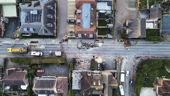 In this photo provided by Surrey Fire and Rescue Service on Wednesday, Feb. 19, 2025, a view of a large sinkhole, in Godstone, England. (Surrey Fire and Rescue Service via AP)