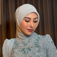 Eyeshadow berwarna coklat dihiasi dengan sedikit shimmer dipadukan dengan eyeliner dan bulu mata palsu. Mempercantik tampilan matanya, Syahnaz juga mengenakan lensa kontak berwarna coklat. Penampilannya makin fresh dan merona dengan pulasan blush on dan lipstik berwarna merah muda kecoklatan. Foto: Instagram/@ochiipramita