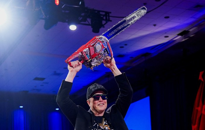 Elon Musk holds a chainsaw onstage as he attends the Conservative Political Action Conference (CPAC) in National Harbor, Maryland, U.S., February 20, 2025. REUTERS/Nathan Howard     TPX IMAGES OF THE DAY