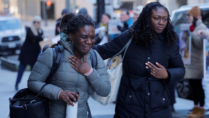 Recently fired U.S. Agency for International Development (USAID) staff react as they leave work and are applauded by former USAID staffers and supporters during a sendoff outside USAID offices in Washington, D.C., U.S., February 21, 2025.   REUTERS/Brian Snyder