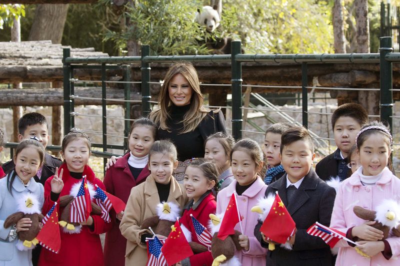 FILE - U.S. first lady Melania Trump and Chinese first lady Peng Liyuan, second right, hold up Chinese calligraphy of the character for 