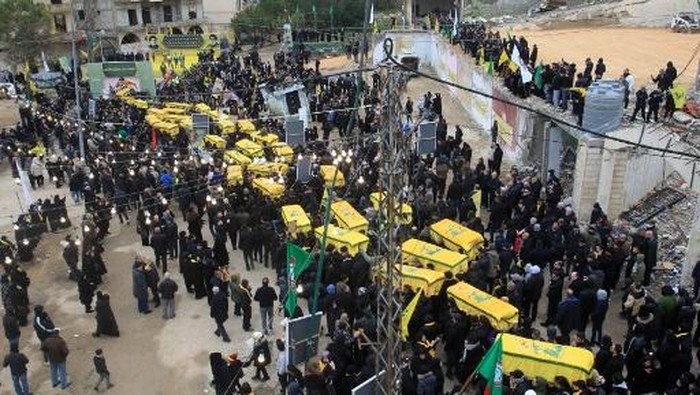 Lebanese mourners attend the funeral of Hezbollah fighters, who were killed in the recent war with Israel, in Ainata in south Lebanon on February 22, 2024. (Photo by Mahmoud ZAYYAT / AFP)