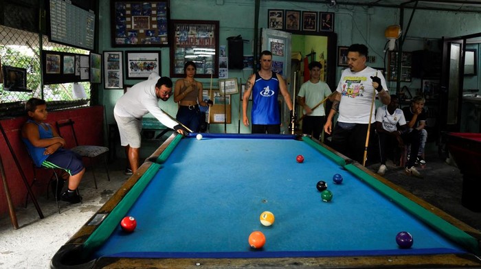 Students play pool at a billiards academy in Havana, Cuba February 17, 2025. REUTERS/Norlys Perez