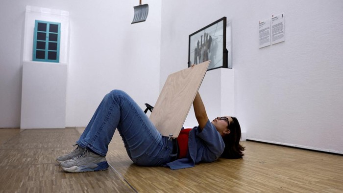 Participants copy art works during a collective performance named 