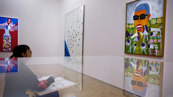 Participants copy art works during a collective performance named 