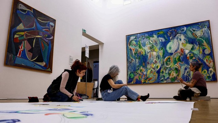 Participants copy art works during a collective performance named 