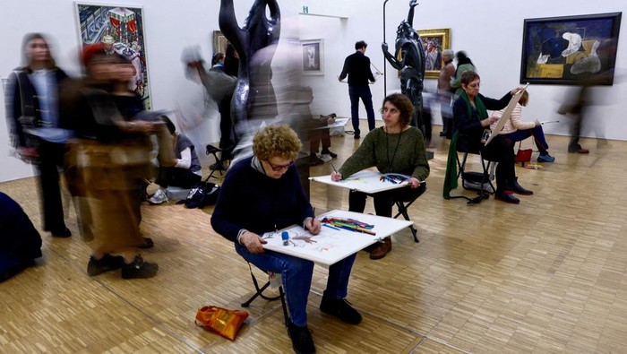 Participants copy art works during a collective performance named 