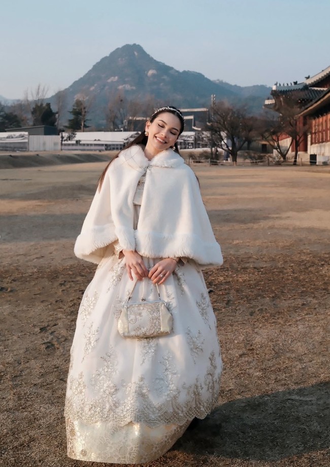 Alyssa tampil elegan dengan memilih Hanbok berwarna putih. Hanbok tersebut dipercantik dengan bordiran berwarna emas dan dilengkapi dengan cape bulu musim dingin yang juga berwarna putih. Foto: Instagram/@alyssadaguise