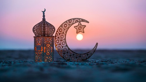 Ramadan Kareem photography, Lantern with crescent moon shape on the beach with sunset sky, 2024 Eid Mubarak  greeting background