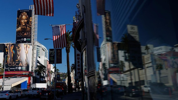 A large billboard sign featuring this years Oscar host Conan O'Brien towers over Hollywood blvd as workers prepare for the 97th Academy Awards in Los Angeles, California, U.S., February 25, 2025. REUTERS/MIKE BLAKE