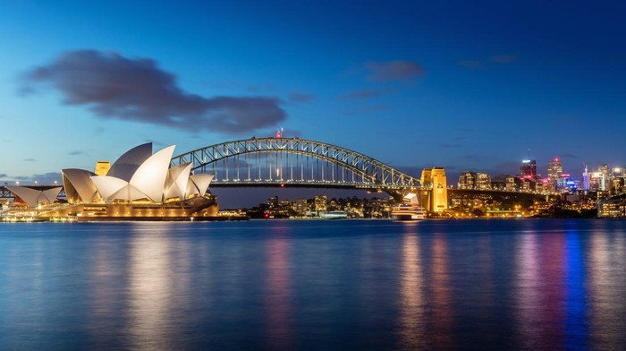 Sydney skyline at twilight. Panorama of the Sydney Skyline. The Sydney Opera House small on the left side, Sydney Harbour Bridge in the middle. Twilight Scenic Sydney Panorama. Sydney, Australia. Canon 5DSR 50MPixel Panorama.