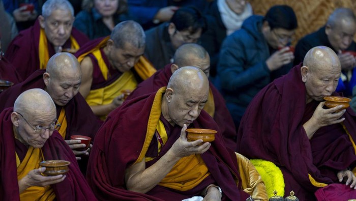 Exiled Tibetan Buddhist monks in yellow ceremonial hats conduct ritual prayers to usher in the Tibetan New Year or Losar at the Tsuglakhang temple in Dharamshala, India, Friday, Feb. 28, 2025. (AP Photo/Ashwini Bhatia)