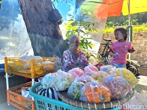 Senyum Lebar Penjual Bunga Ziarah Makam di Mataram