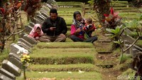 Peziarah membawa anak dan istri untuk memanjatkan doa bagi anggota keluarganya yang sudah terlebih dahulu menghadap Sang Pencipta.